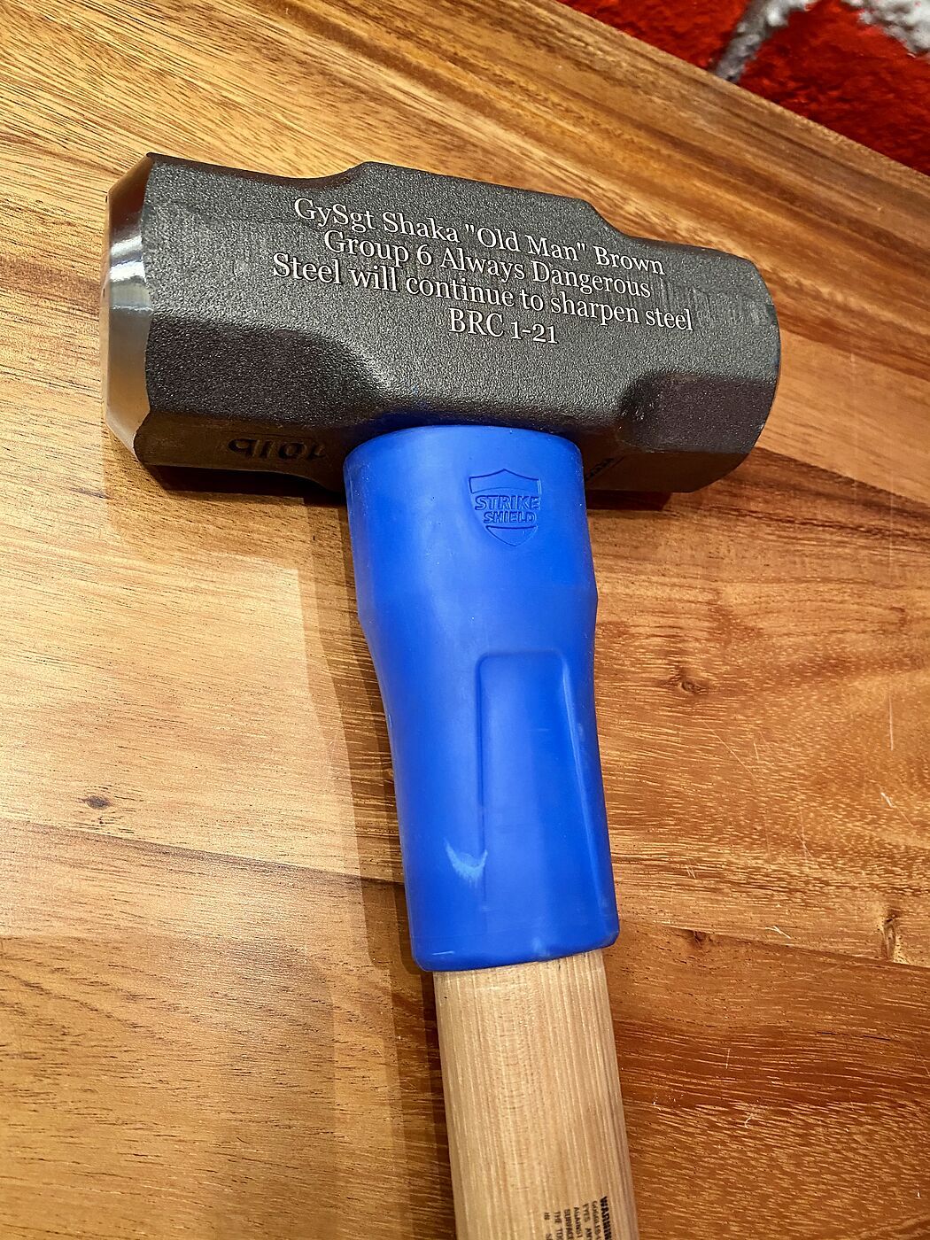 Sledgehammer with a Gunnery Sergeant retirement message engraved on the steel head